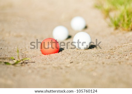 golf balls in sand trap