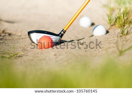 playing golf in sand trap