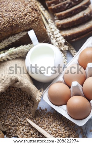 Fresh bread, milk, eggs - healthy breakfast concept