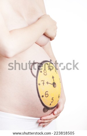 Conceptual image of pregnant belly with painted clock