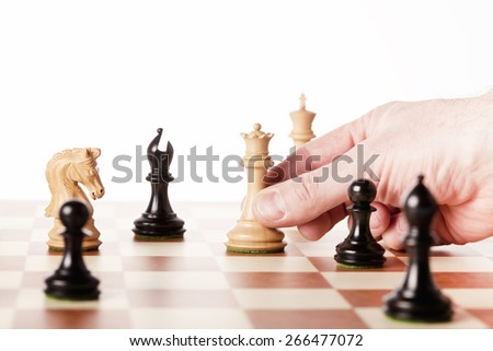 chess game,moving white chess queen n a chessboard