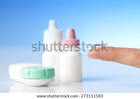 contact lens on finger , case and eye and allergy treatment eye drops