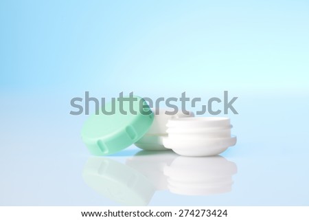 contact lenses case on blue background