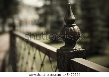 urban concept with wrought iron fence detail ( selective focus  on nearest part)