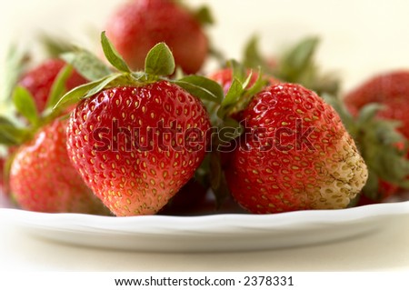 fresh red strawberries(focus point on the nearest berry,special warm soft f/x)
