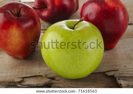 four apple on wood background