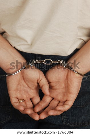 criminal with hands cuffed behind back