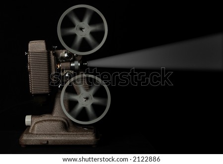vintage movie projector running against dark background