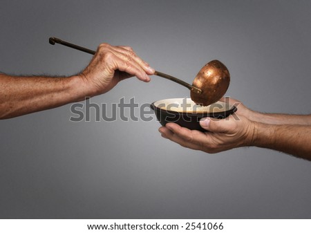 man holding a bowl in both hands, receiving a serving of soup from another man holding a soup ladle