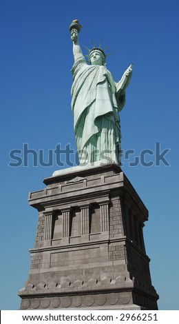 Worm\'s eye view of the Statue of Liberty on a clear day with a blue sky