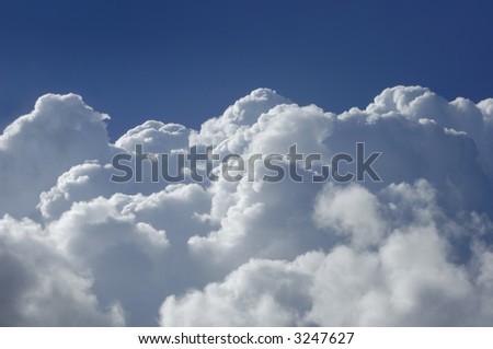Cumulus clouds shot from a high altitude against a blue sky