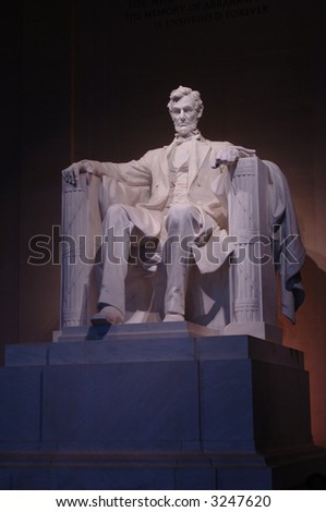 Interior of Lincoln Memorial in Washington DC facing the carved stone statue of Abraham Lincoln at night