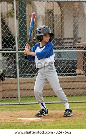 A young boy up to bat in a baseball game