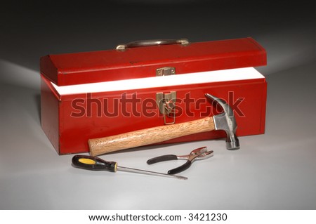 Red toolbox partially opened with light rays emitting from inside the box