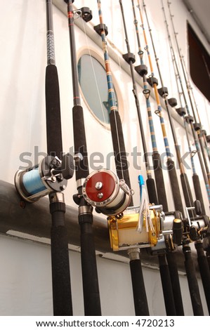 Deep Sea fishing poles lined up on the side of a boat