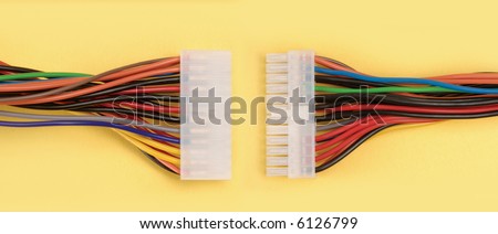 Two computer cables with multi-colored wires about to connect