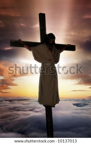 Jesus Christ on the cross with sunburst & clouds behind him.