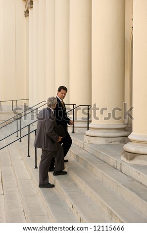 Attorney and client walking up the steps of a courthouse
