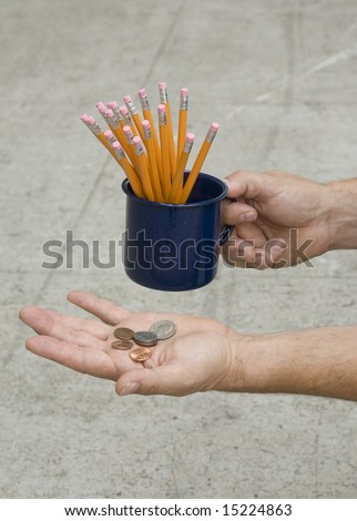 Close-up of a hand holding a cup of pencils with the other hand holding a palm of change