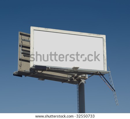 Blank freestanding billboard against a dark blue sky with clipping path for ad area