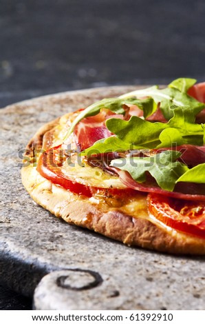 Homemade pizza served on a stone serving dish