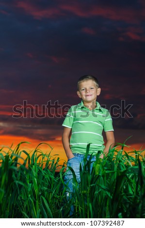 happy young man rest on green field after the storm