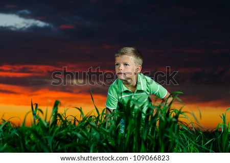 happy young man rest on green field after the storm