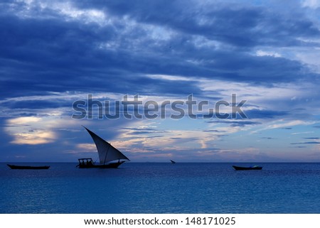 Fishermen Dhow Boat coming back home at sunset from a long day in the sea. Taken at Nungwi village, Zanzibar Island, Tanzania