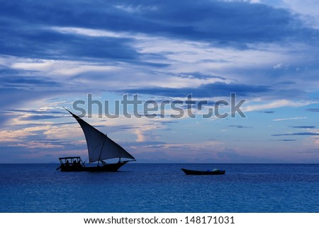 Fishermen Dhow Boat coming back home at sunset from a long day in the sea. Taken at Nungwi village, Zanzibar Island, Tanzania