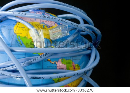 Network cable wrapped around a globe depicting a connected world