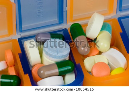 Closeup of different kinds of pills in a pill box