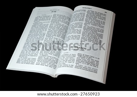 Open bible at the book of Revelation isolated on black background