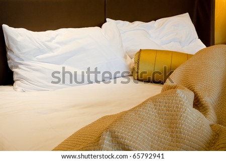 Messy luxurious bed with pillow and quilt cover