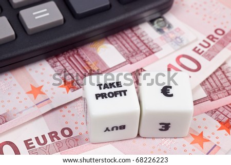 Euro currency with calculator and dice showing TAKE PROFIT