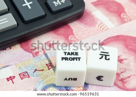 Chinese currency with calculator and dice showing TAKE PROFIT