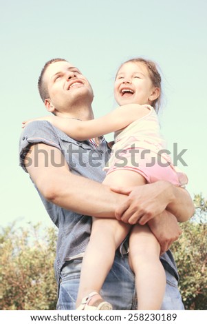 Happy little girl on uncle hug