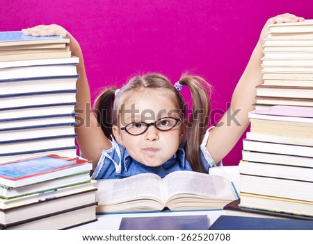 Little scholar girl with pile of books - learning concept