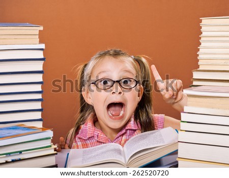 Little scholar girl with pile of books - idea concept