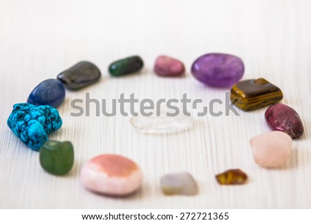 Crystals in shape of circle with clean quartz stone in middle, every with different energy for spiritual and body healing