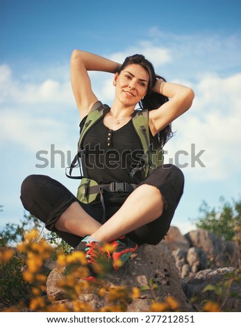 Woman hiking in beautiful nature, back light by morning sunlight rays, recreation and healthy lifestyle outdoors in wild. Hiker backpacker walking on mountain top.