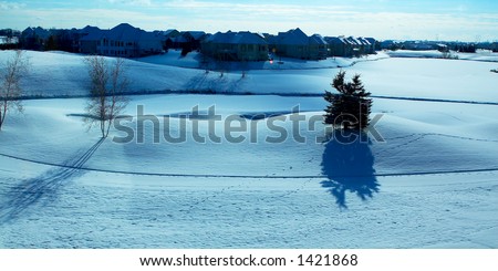 Curvy landscape on the snow covered golf course. More with keyword Group1.