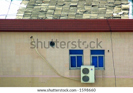Roof, window, and AC unit with run-down tiles.