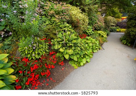 A path through arranged flowers in Vancouver Queen Elizabeth Park. More with keyword group14h