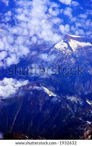 Snowy mountain peaks under the cloud. More with keyword group14a