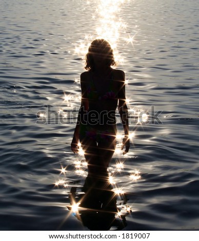 Girl in patches of light on sea