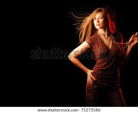 pretty girl with long fluttering hair on black background