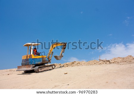 Excavator machine work on the earth mountain
