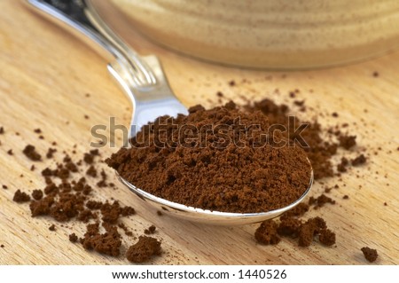 A tea spoon full of instant coffee granules.