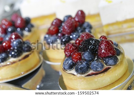 set of cakes with berries on the table