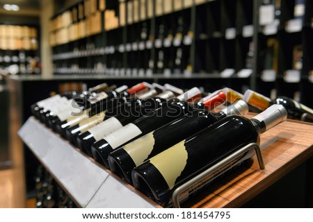Red and white wine in bottles in wine shop